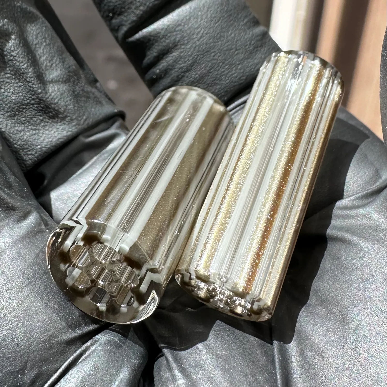 Electrum Grey glass tips shown in hand for size reference