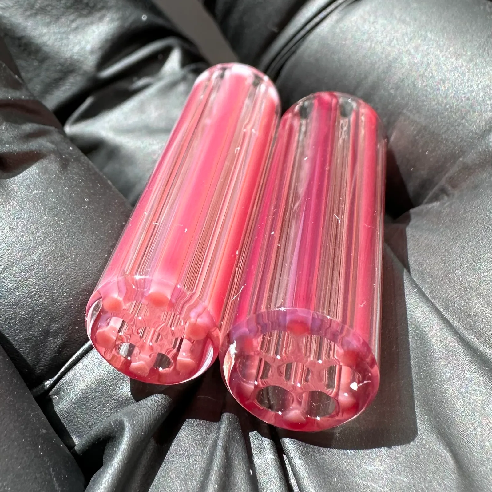 Metal Phoenix borosilicate glass tips shown in hand for size reference